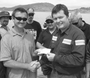 Scott Buckingham of Rio Tinto handing over cheque to Anthony O,Donoghue for bass fingerlings and 